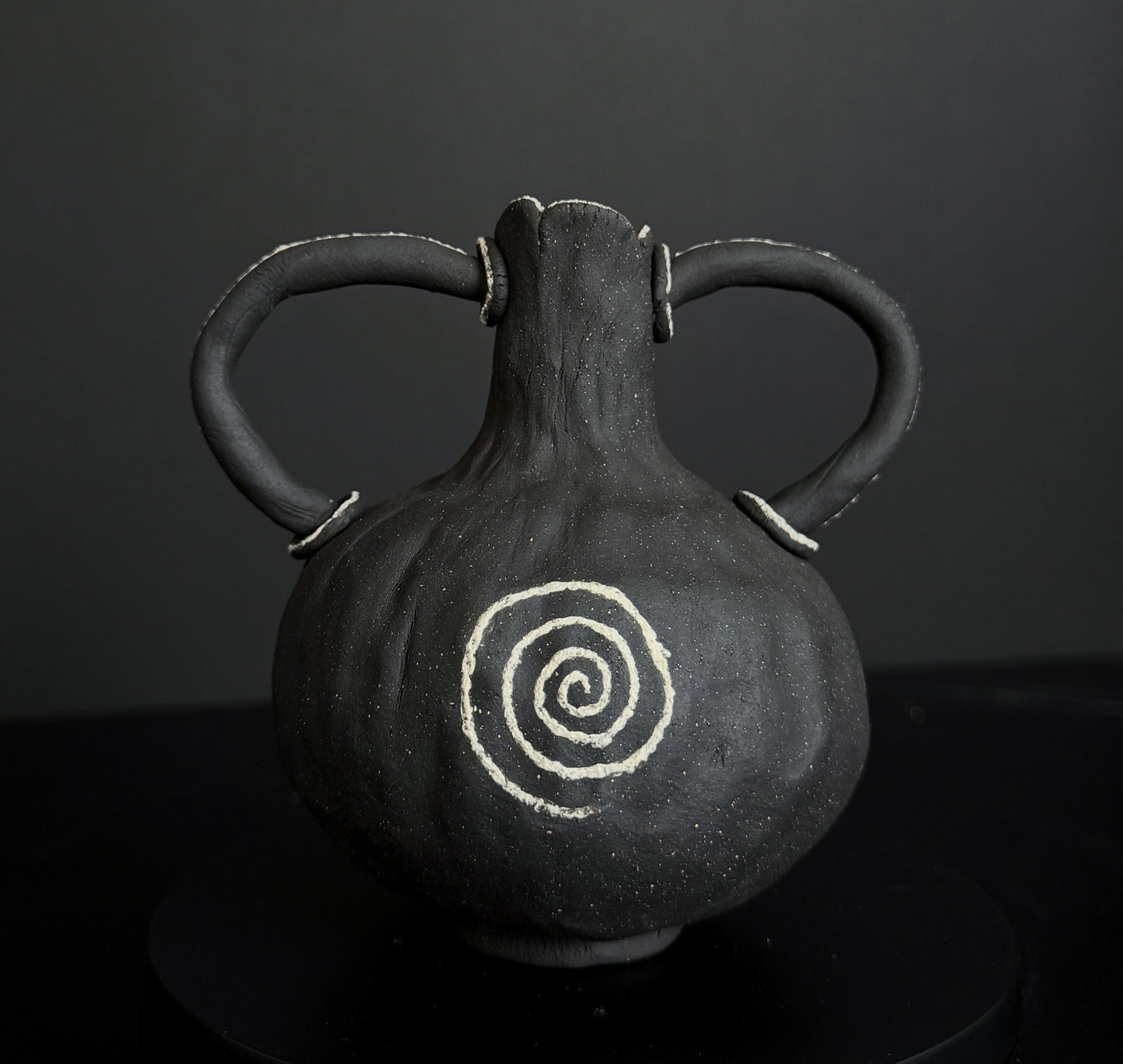 Miniature Dark Clay Vessel with Spiral Motif